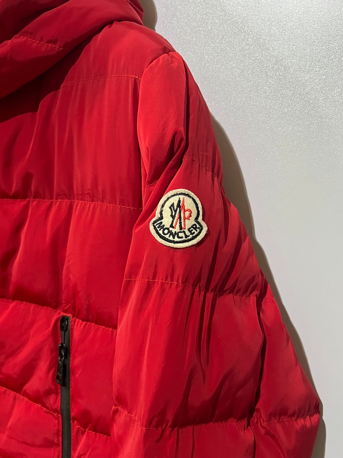 Moncler puffer jacket features bold branding along the inner zipper placket