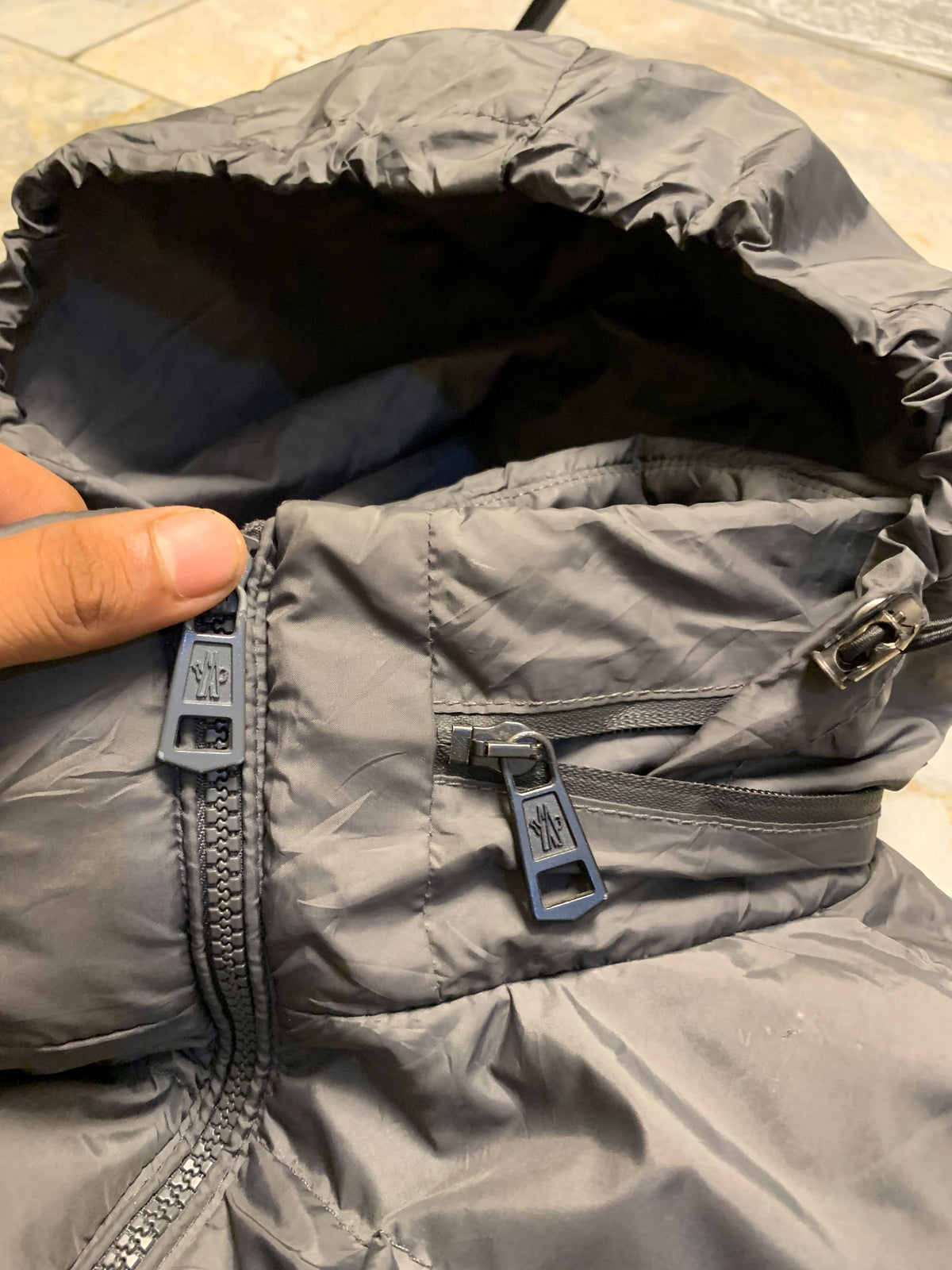 Moncler logo patch on the left sleeve, resembling a Moncler down jacket. [1]