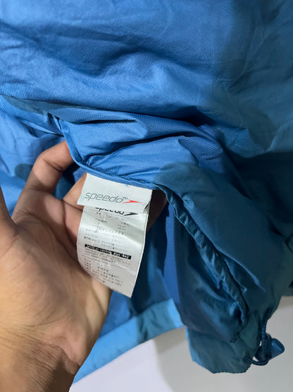 Speedo puffer jacket features a high collar and quilted construction for warmth.
