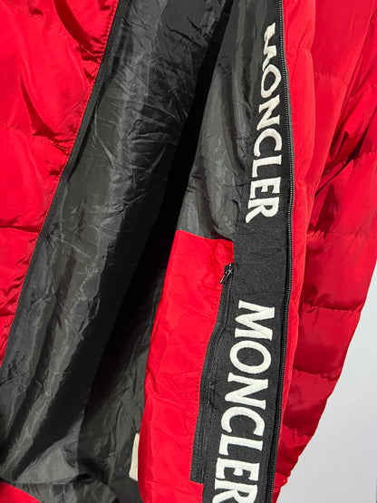 Moncler puffer jacket features bold branding along the inner zipper placket