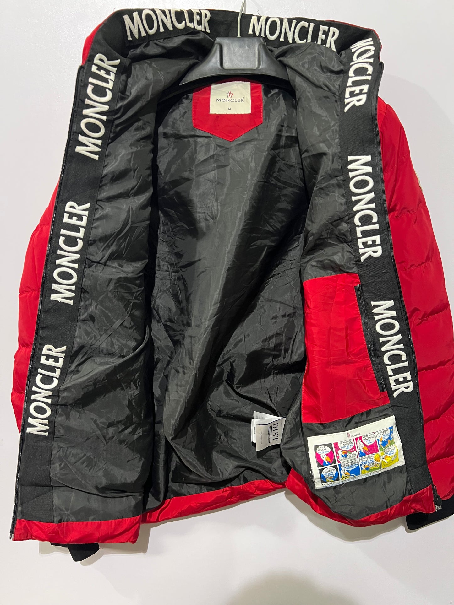 Moncler puffer jacket features bold branding along the inner zipper placket