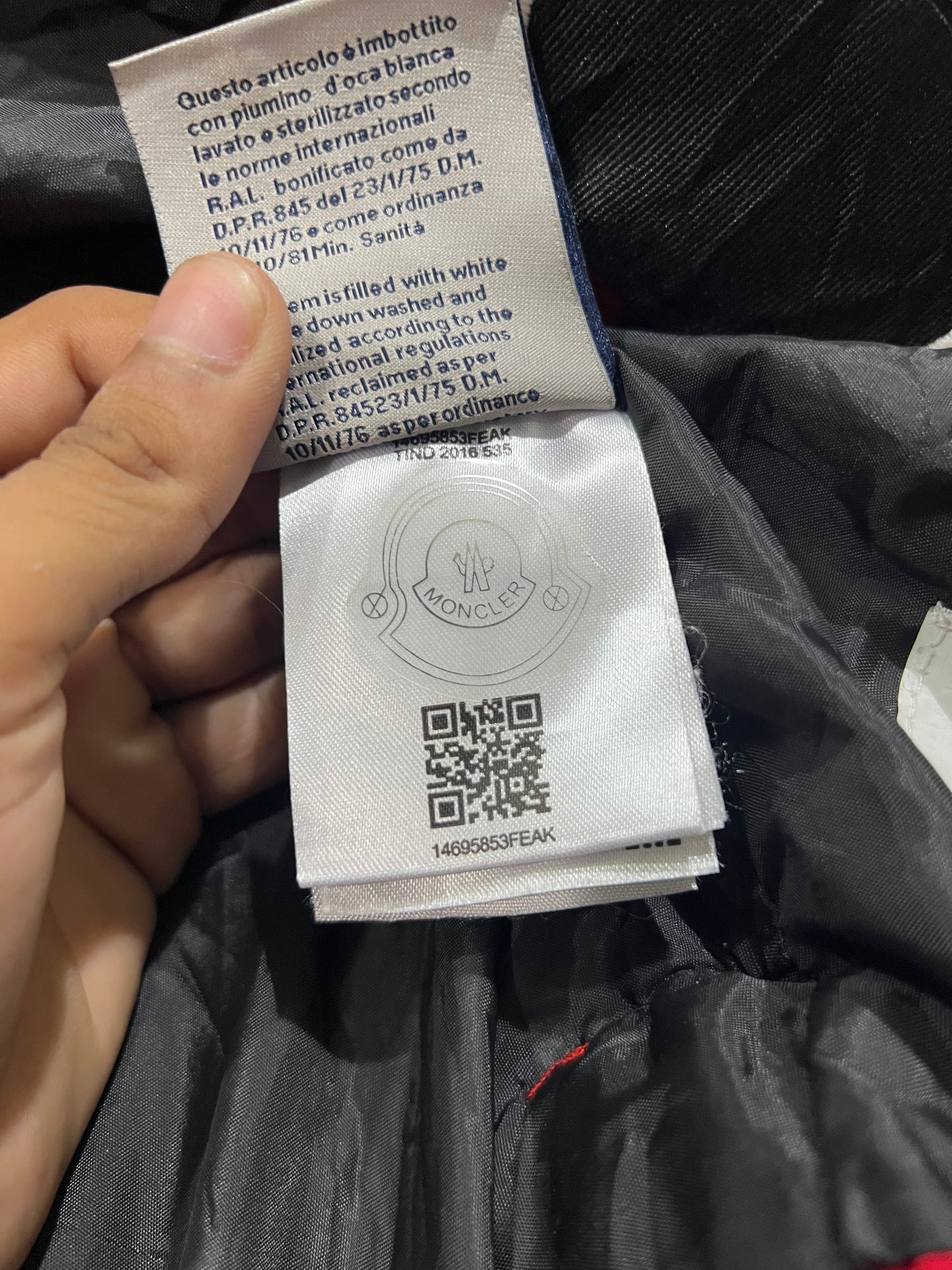 Moncler puffer jacket features bold branding along the inner zipper placket