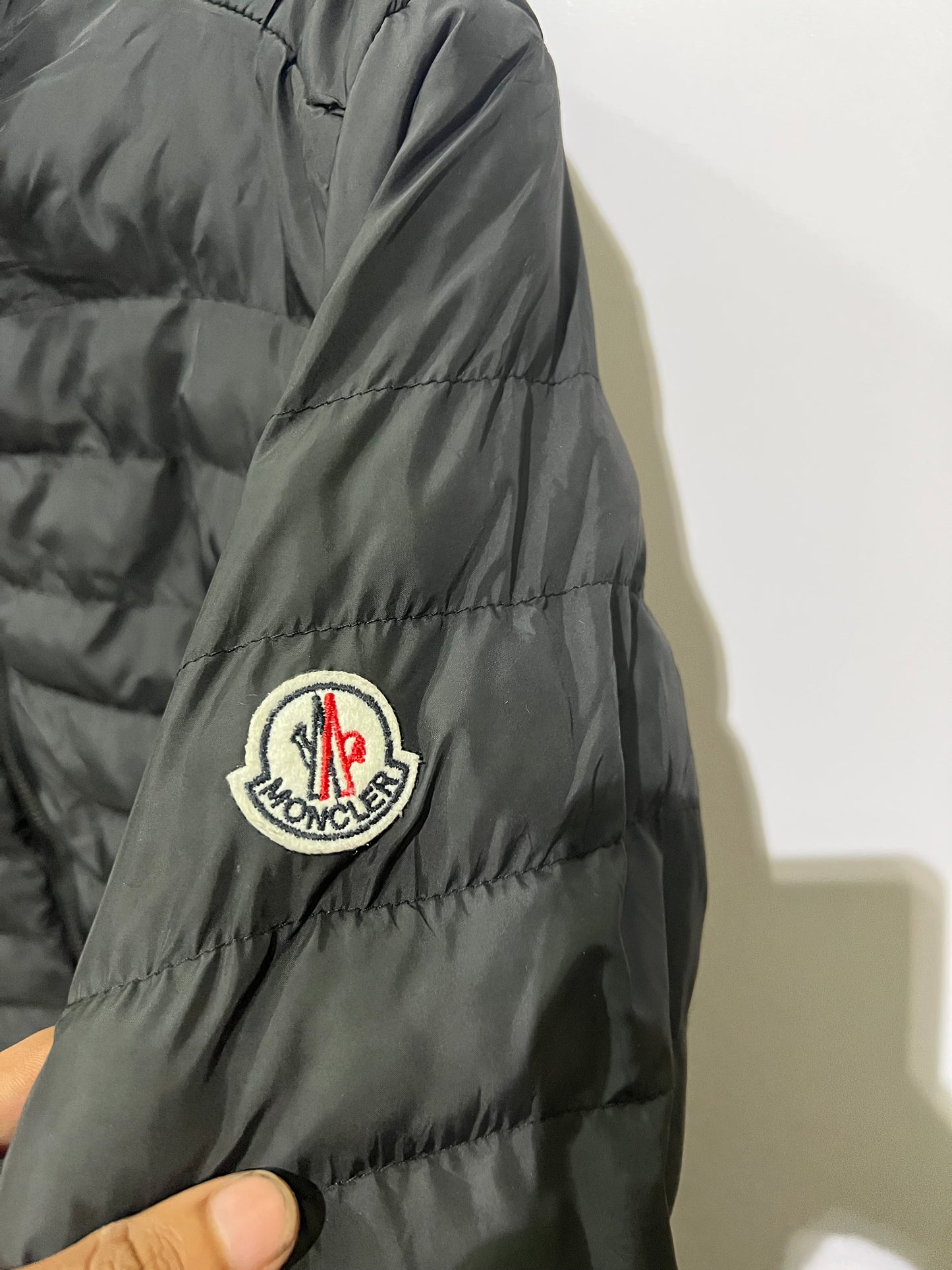 Moncler Hanriot puffer jacket featuring a black quilted