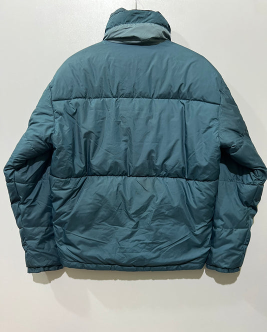 vintage teal Helly Hansen puffer jacket features a prominently embroidered logo