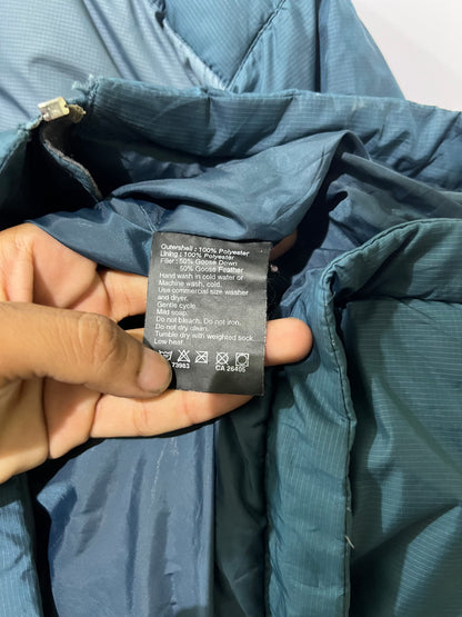 vintage teal Helly Hansen puffer jacket features a prominently embroidered logo