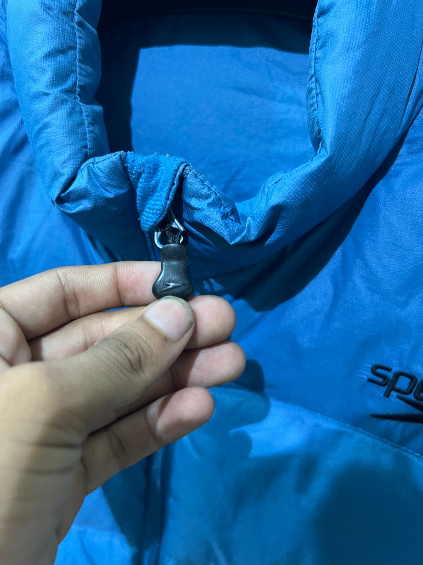 Speedo puffer jacket features a high collar and quilted construction for warmth.