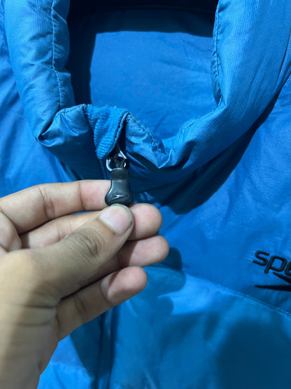 Speedo puffer jacket features a high collar and quilted construction for warmth.