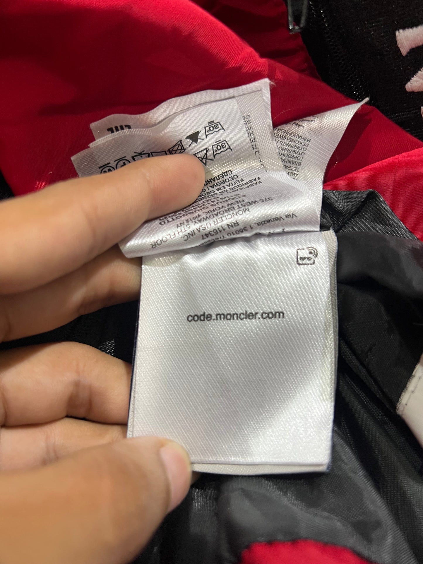 Moncler puffer jacket features bold branding along the inner zipper placket