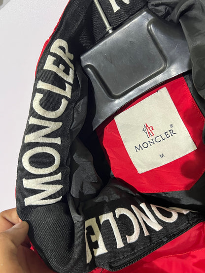 Moncler puffer jacket features bold branding along the inner zipper placket