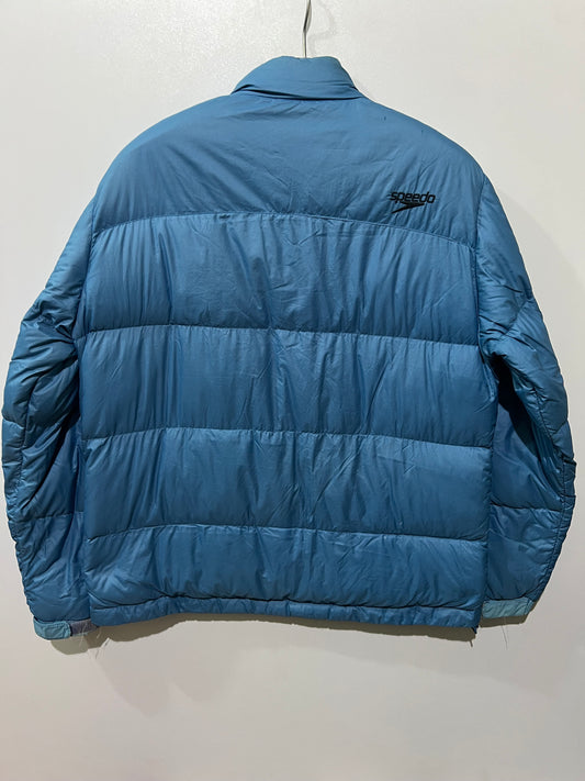 Speedo puffer jacket features a high collar and quilted construction for warmth.